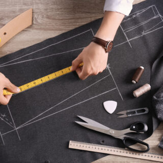 Tailor working at table in atelier -espero